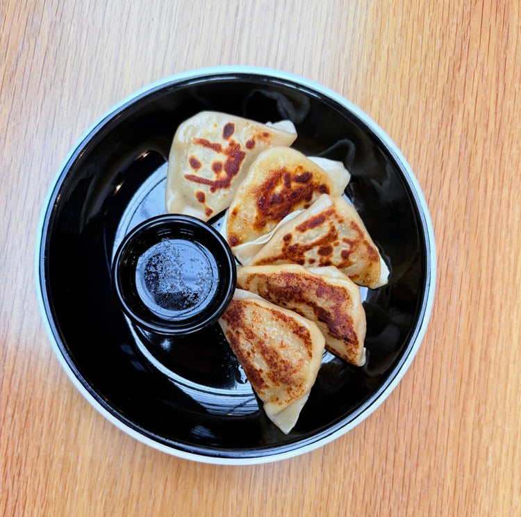 Pan-fried handmade gyoza with dipping sauce