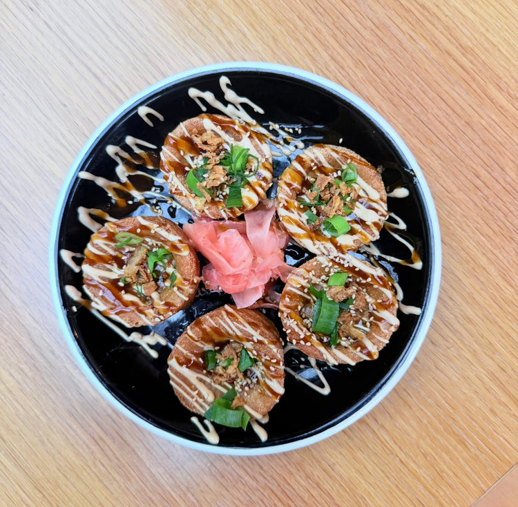Yorkie Pud Bombs drizzled with sauce and topped with spring onions and sesame